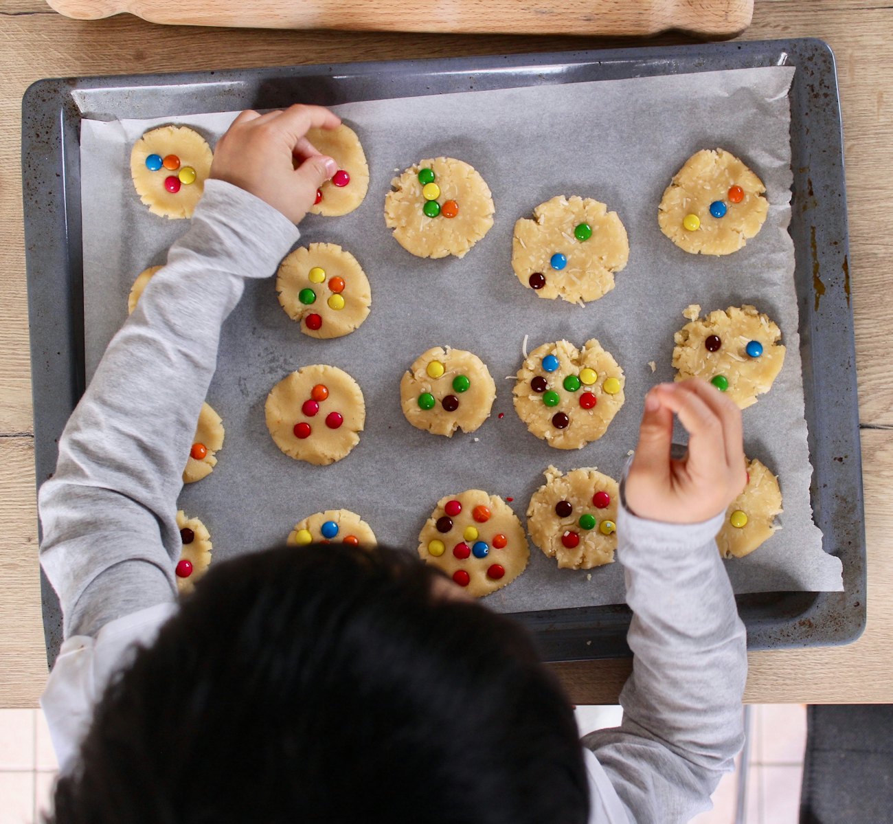 A parent and child baking together in the kitchen